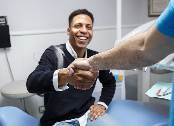 patient shaking dentist's hand