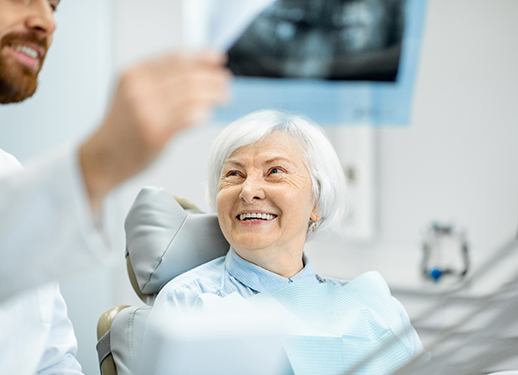 Older woman smiling during her dental consultation