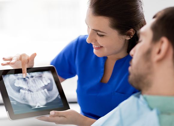 team member pointing to tooth on x-ray