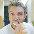 Man brushes teeth