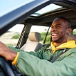 Man smiles while driving