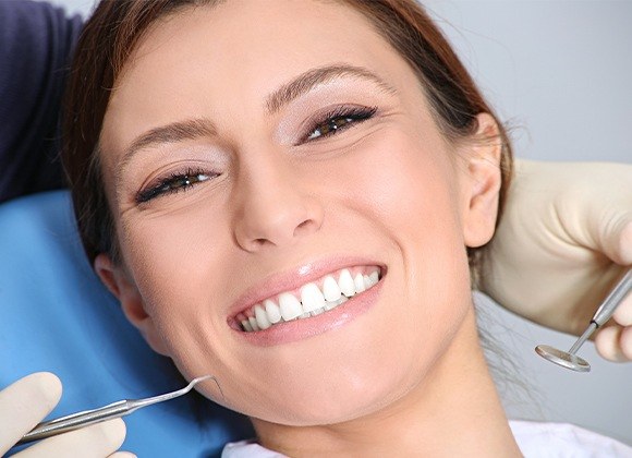 woman smiling up in exam chair