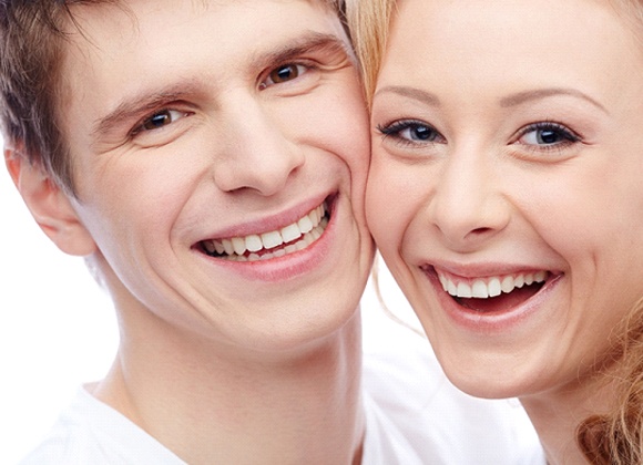 A young man and young woman smiling