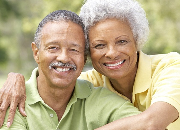 husband and wife smiling