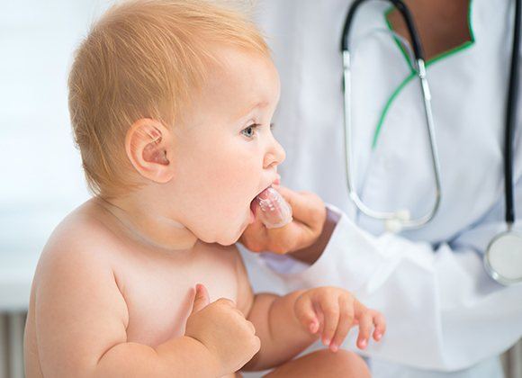 dentist brushing babies teeth