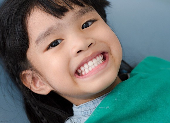 young girl showing off teeth