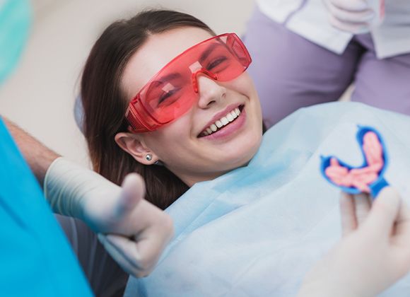 young girl holding fluoride tray