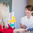 dental team member showing paperwork to a patient