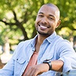 smiling man sitting in nature