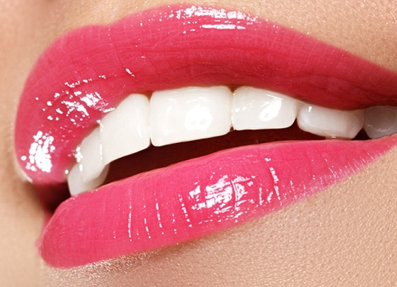 close up of mouth with white teeth and glossy lips