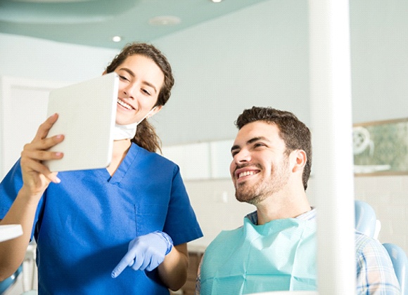 male patient talking to dental professional about digital smile design