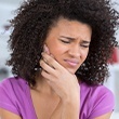 woman in purple in pain