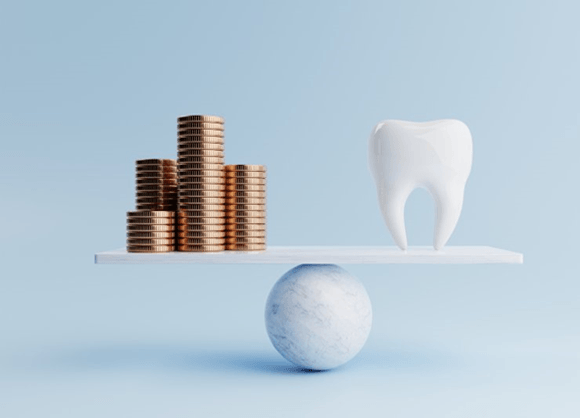 a scale with coins and a tooth