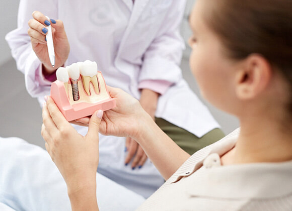 dentist showing a patient how dental implants work in Waverly