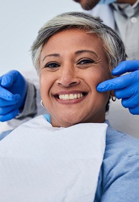 Woman smiling while sitting in the patient’s chair