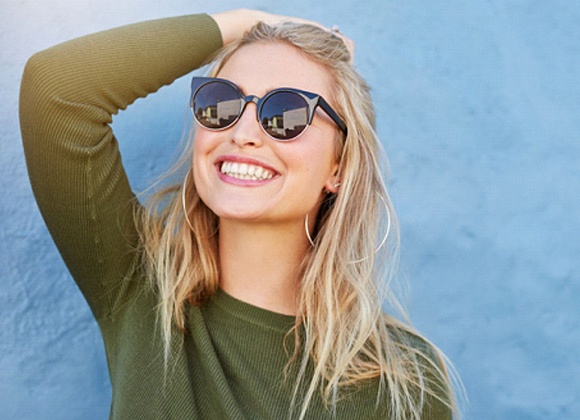 woman smiling wearing sunglasses
