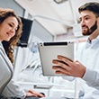 Dentist and patient looking at a tablet