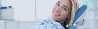 woman smiling in blue chair