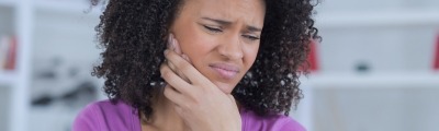 woman holding jaw