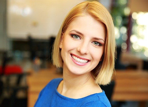 woman in blue shirt smiling