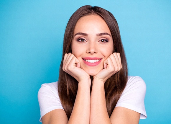 Young woman showing off beautiful teeth after smile makeover