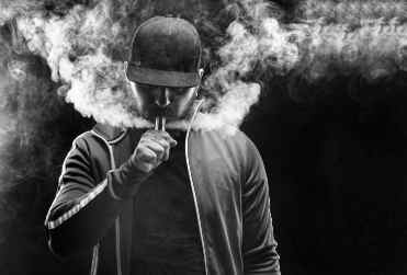 Man exhaling vape smoke