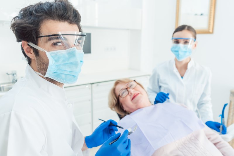 Dentist in Waverly wearing face shield