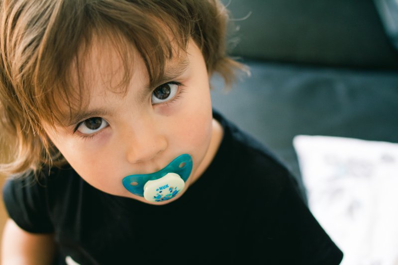 child sucking on a pacifier