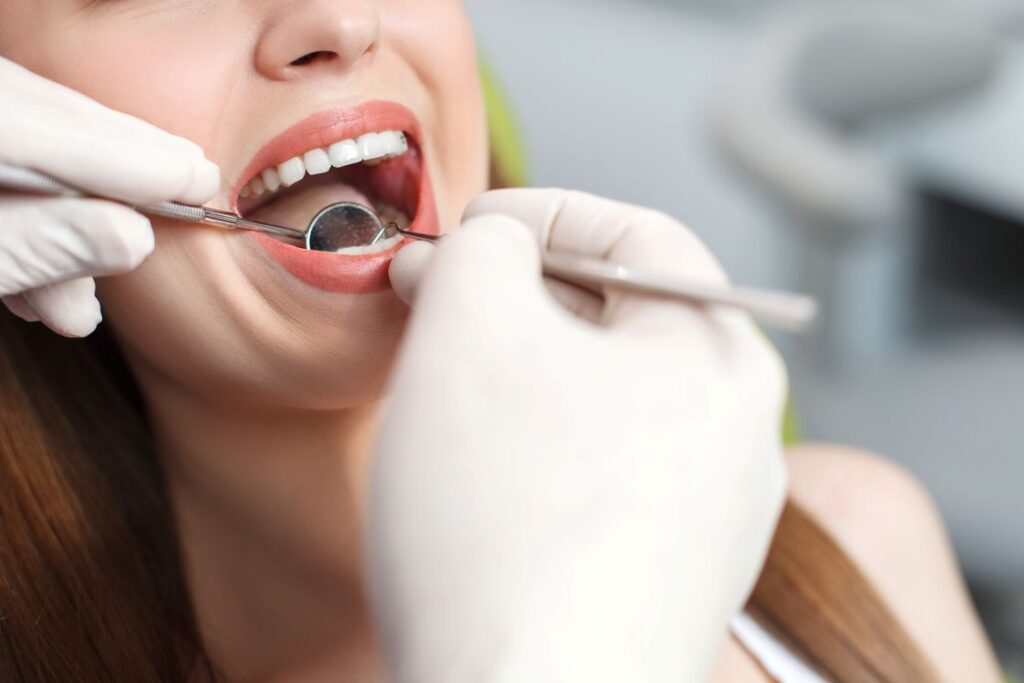 A woman getting her teeth examined by a dentist
