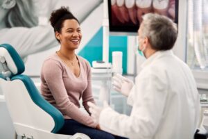 Woman at dental checkup telling the truth about her oral health